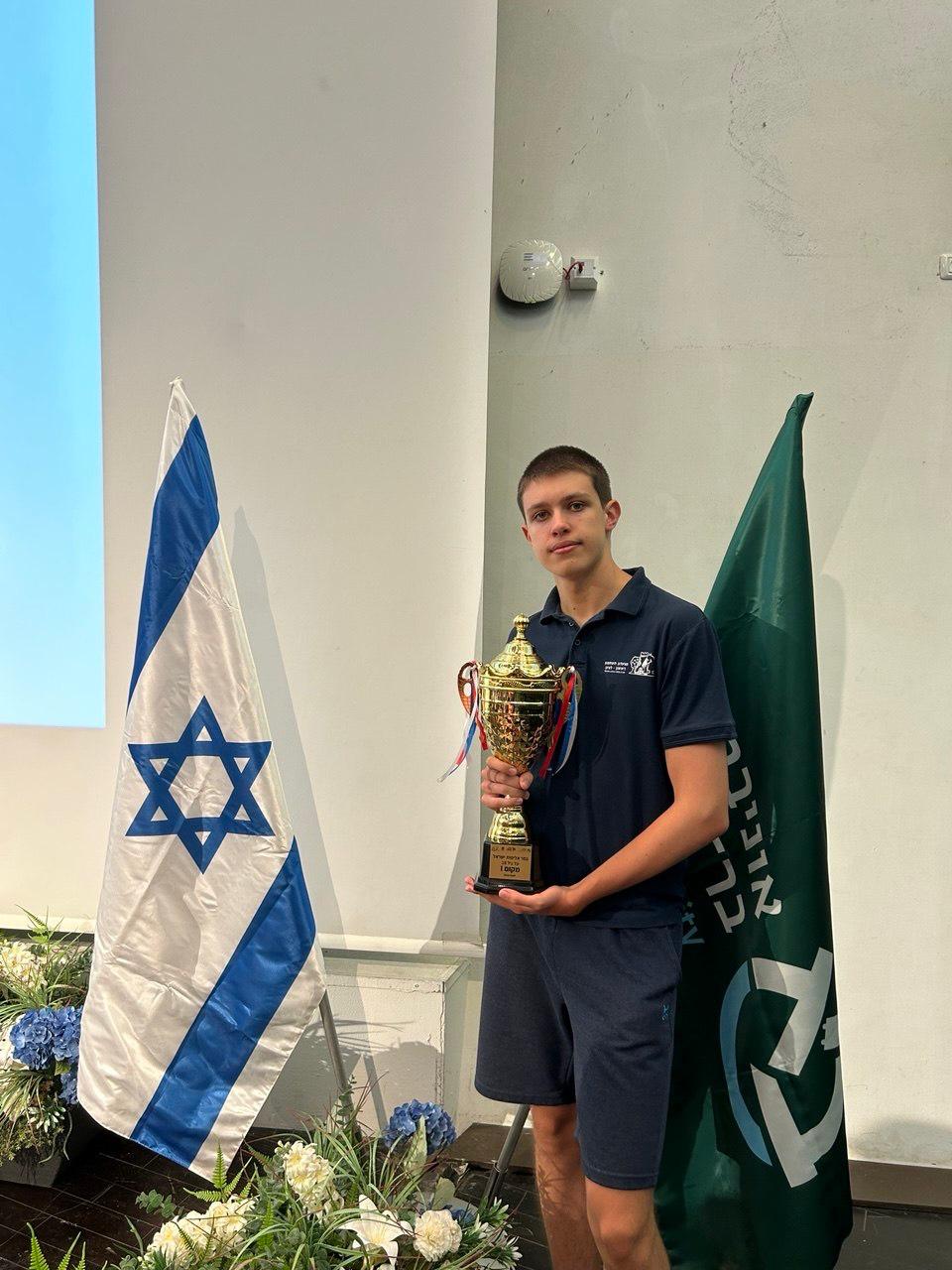 Felix Tulchinsky with a trophy at a youth chess event.